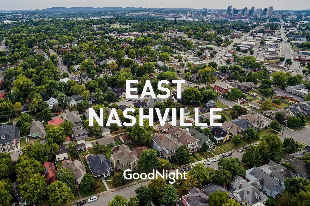 A broad view of East Nashville’s residential neighborhoods with the downtown skyline and green parks in the background. The scene feels welcoming and hints at the area's eclectic vibe, urban exploration, and the cultural richness awaiting couples just beyond their condo.