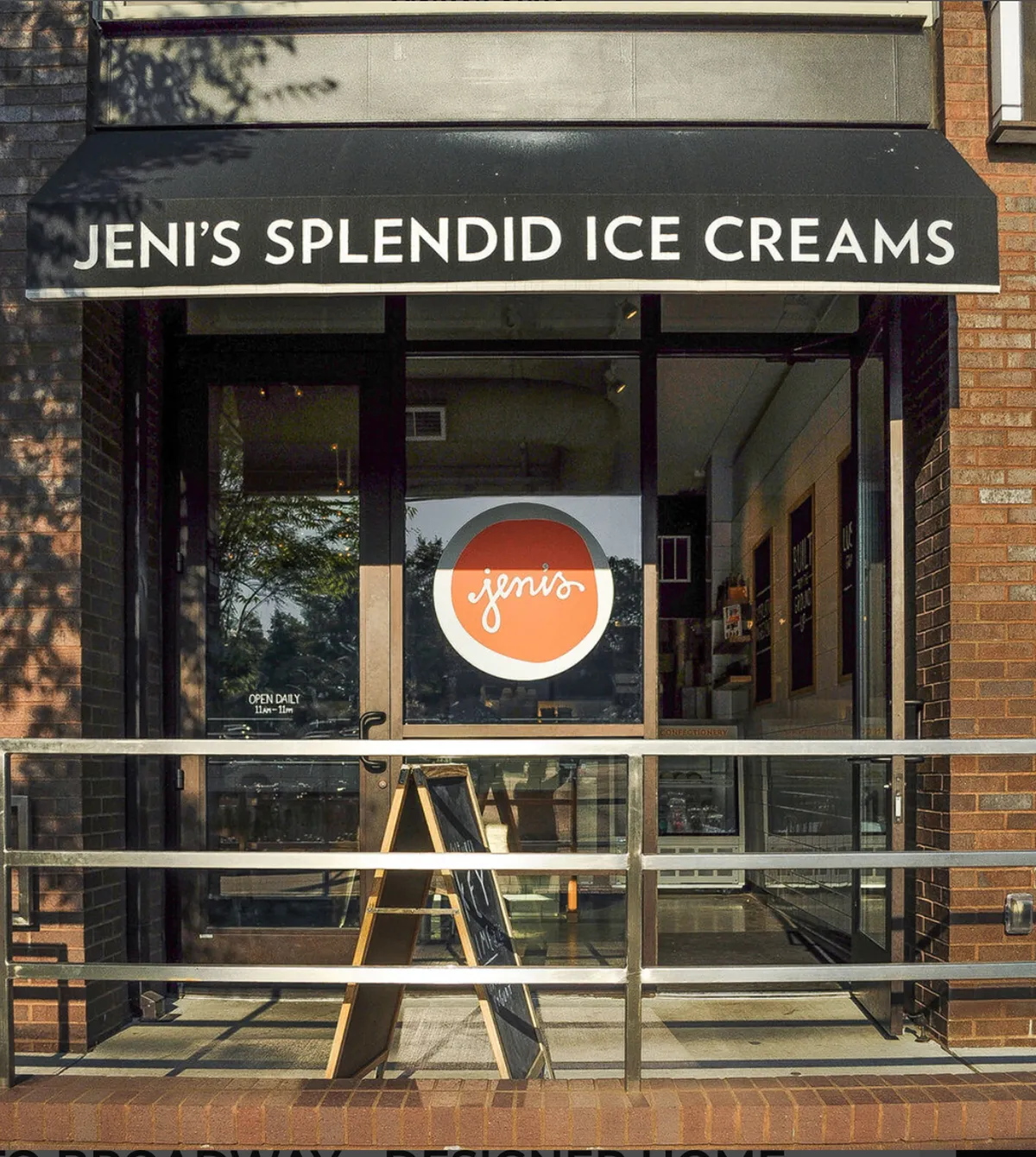 The image features the cheerful storefront and outdoor seating area of an ice cream shop, with people enjoying their treats on the patio. The inviting setting highlights the communal, relaxed vibe of a beloved local hangout spot, perfect for couples seeking a casual, fun date night.