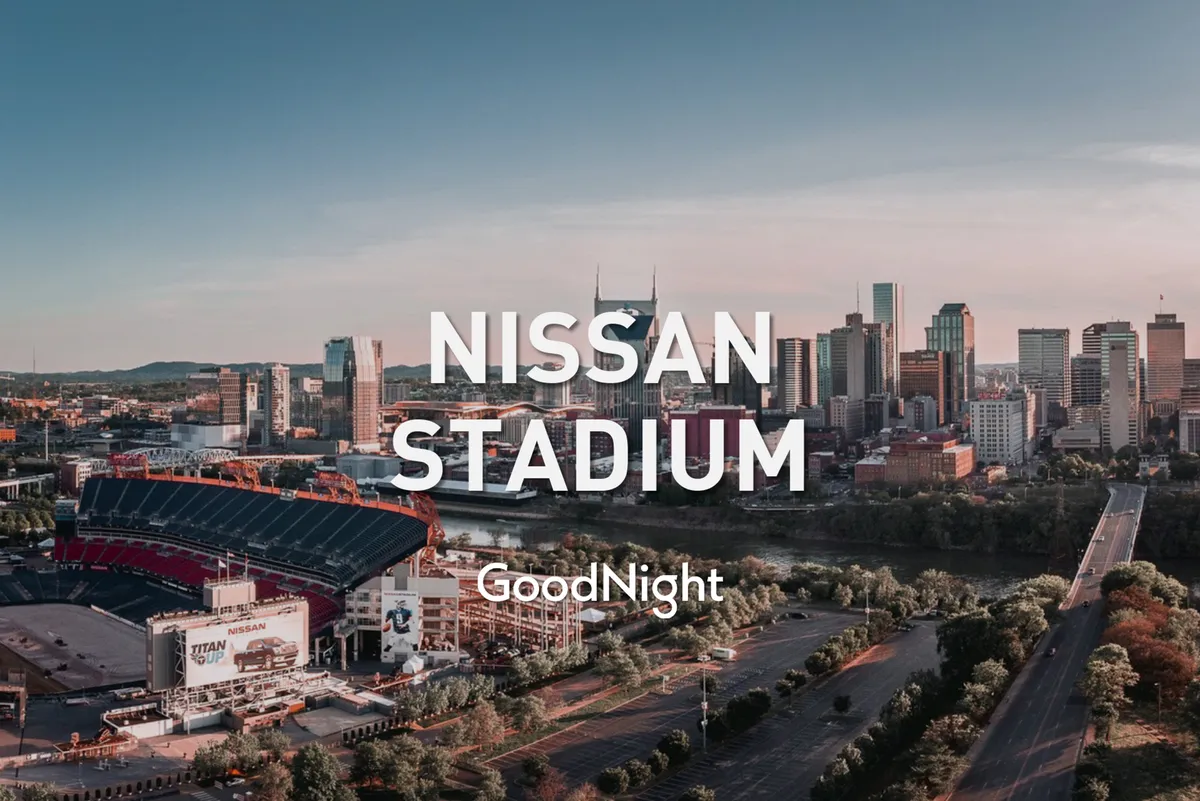 This image offers a sweeping view of Nissan Stadium set against Nashville’s vibrant city skyline and the riverfront. The scene captures the excitement of attending live sporting events and the energy of downtown exploration, with roadways leading into the heart of the city.
