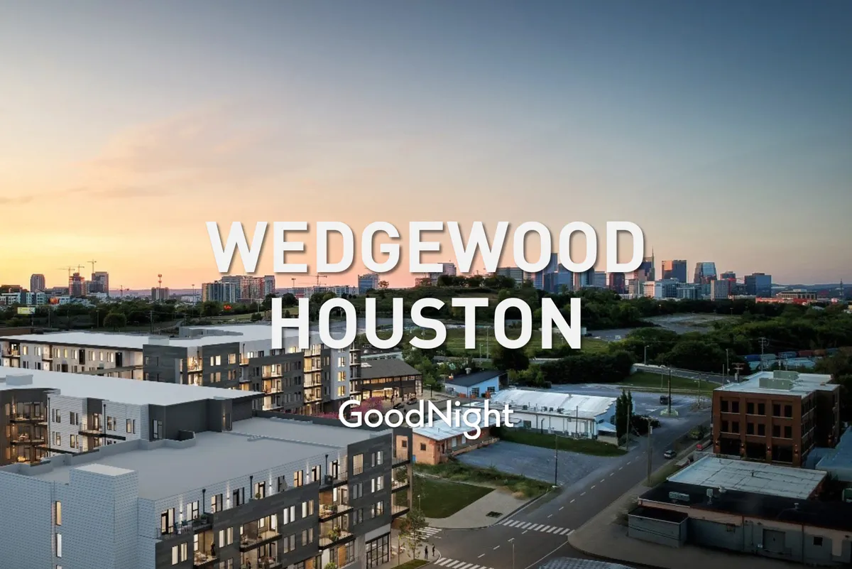 A welcoming view of modern apartment buildings set against a colorful sunset skyline. The photo suggests a sense of community and the convenience of living close to Nashville’s key attractions, with social gatherings on balconies and a lively neighborhood atmosphere.